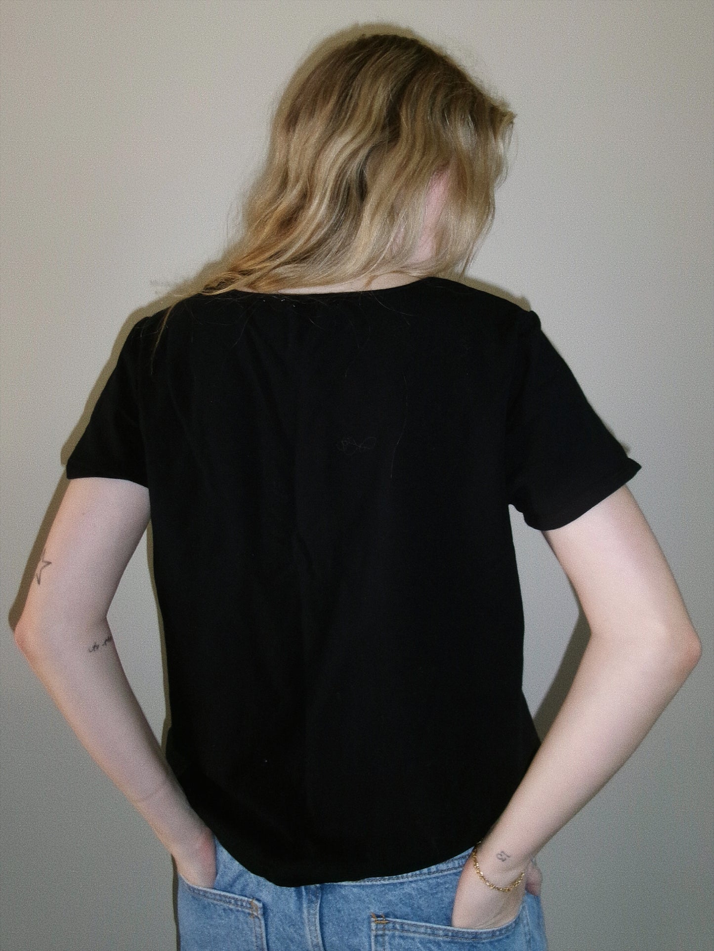vintage black tee with metal detail around neckline back