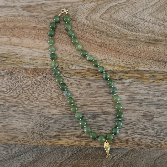 green and gold beaded necklace with brass fish charm and gold lobster clasp