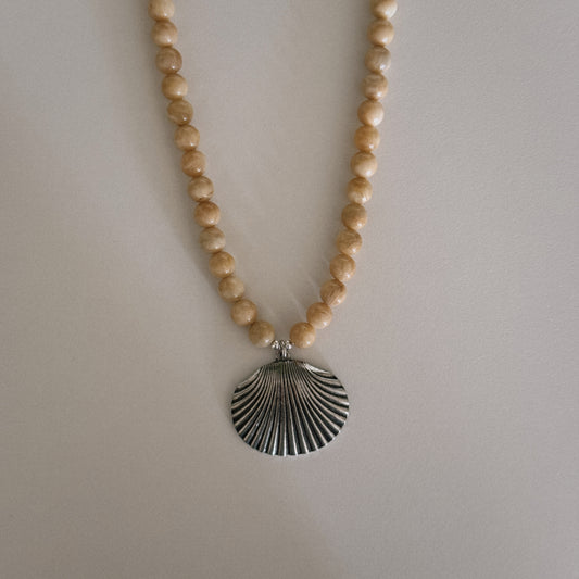 yellow beaded necklace with shell pendant