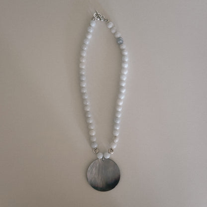 pale blue beaded necklace with mother of pearl shell