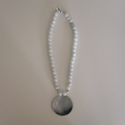 pale blue beaded necklace with mother of pearl shell