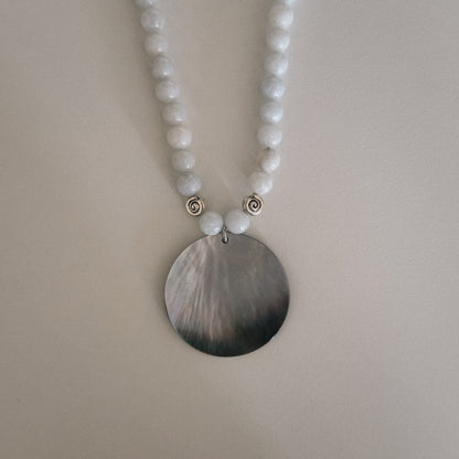 pale blue beaded necklace with mother of pearl shell