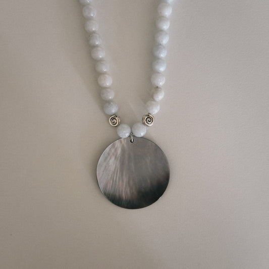 pale blue beaded necklace with mother of pearl shell