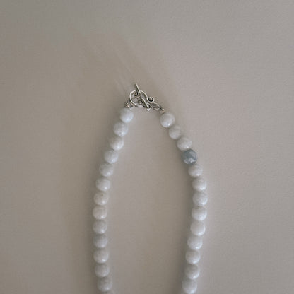 pale blue beaded necklace with mother of pearl shell