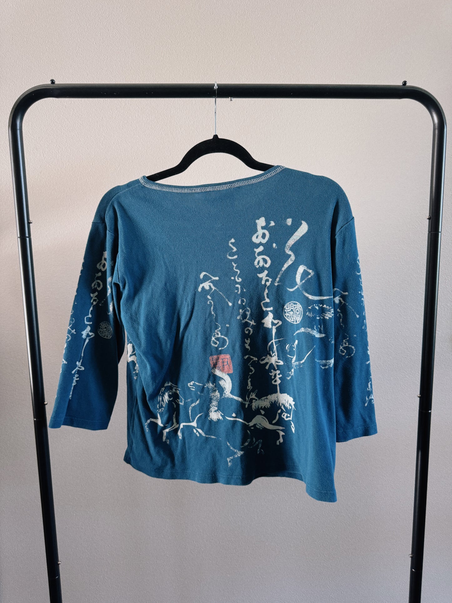 teal calligraphy top