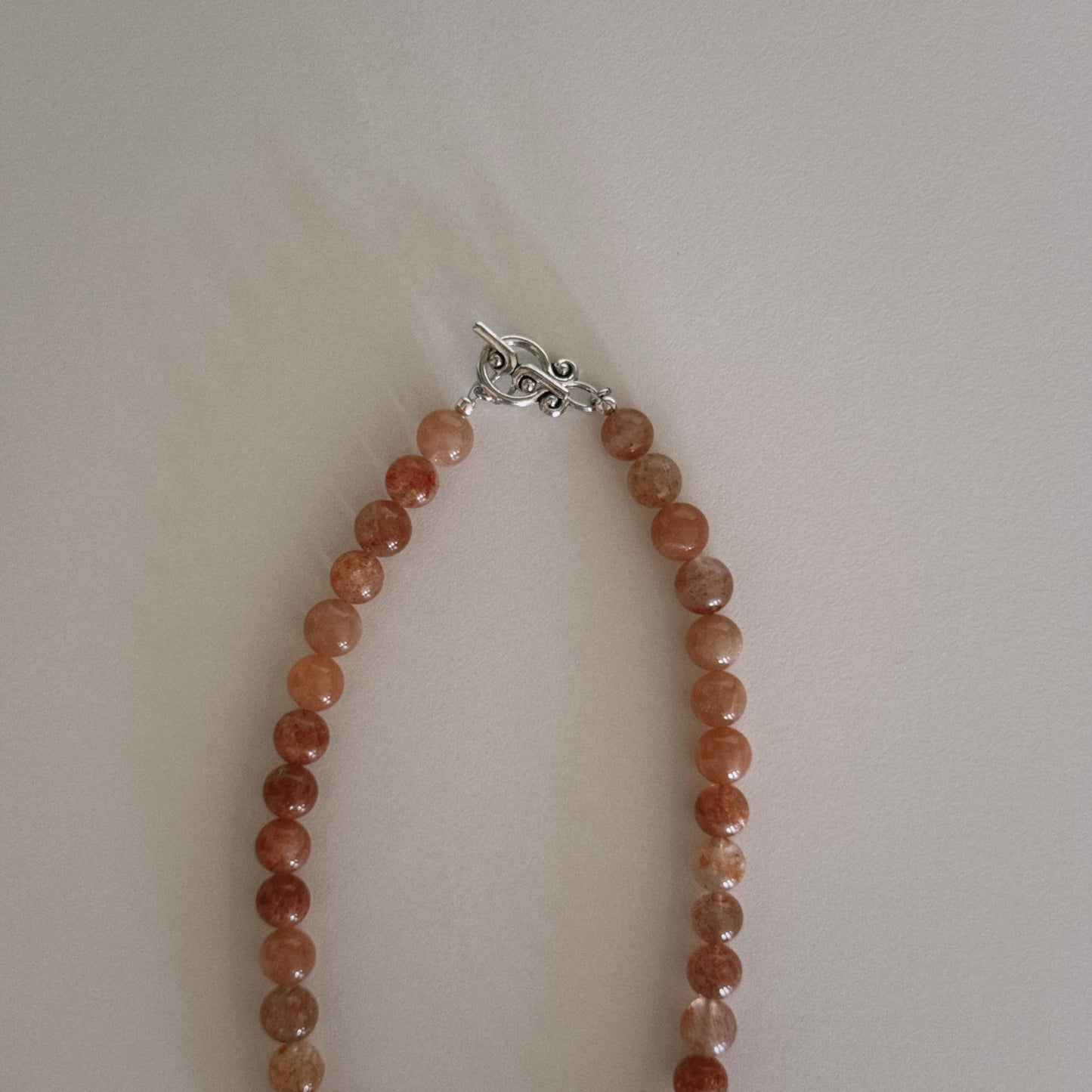pink sunstone beaded necklace with oyster pendant