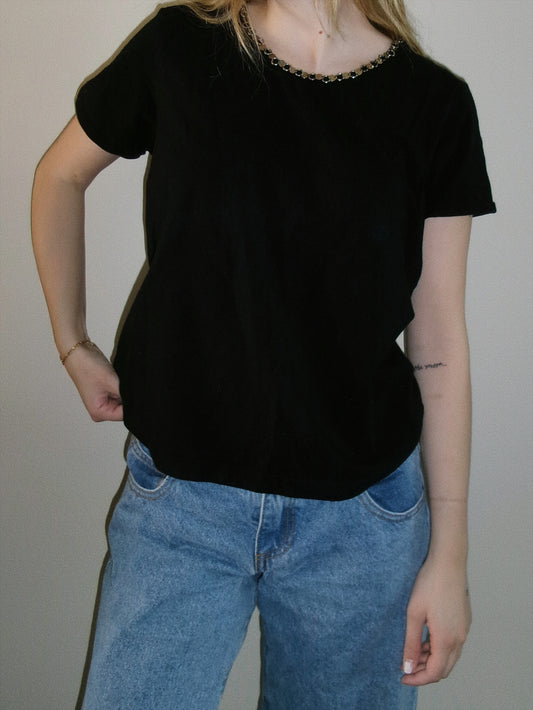 vintage black tee with metal detail around neckline