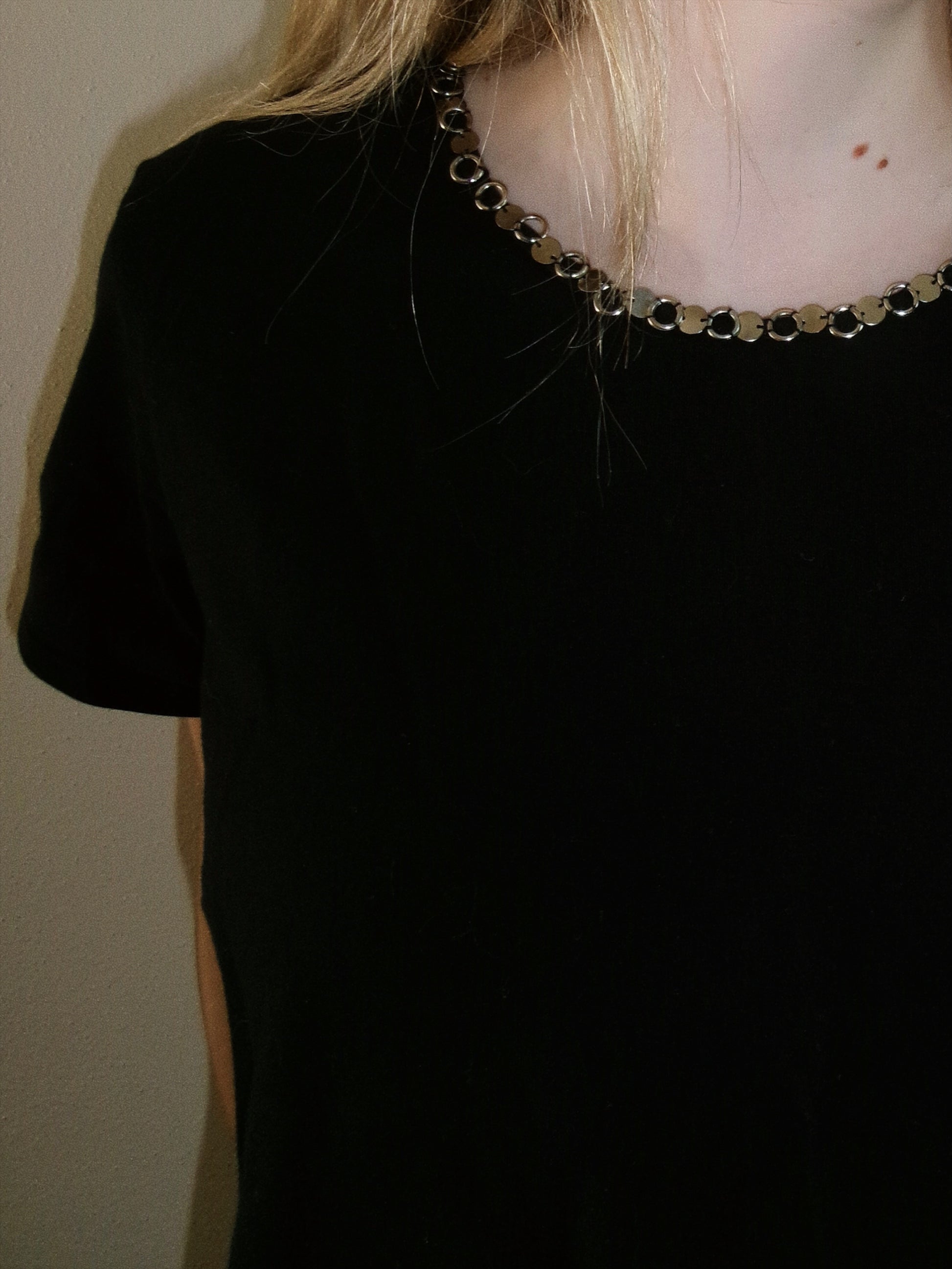 vintage black tee with metal detail around neckline detail