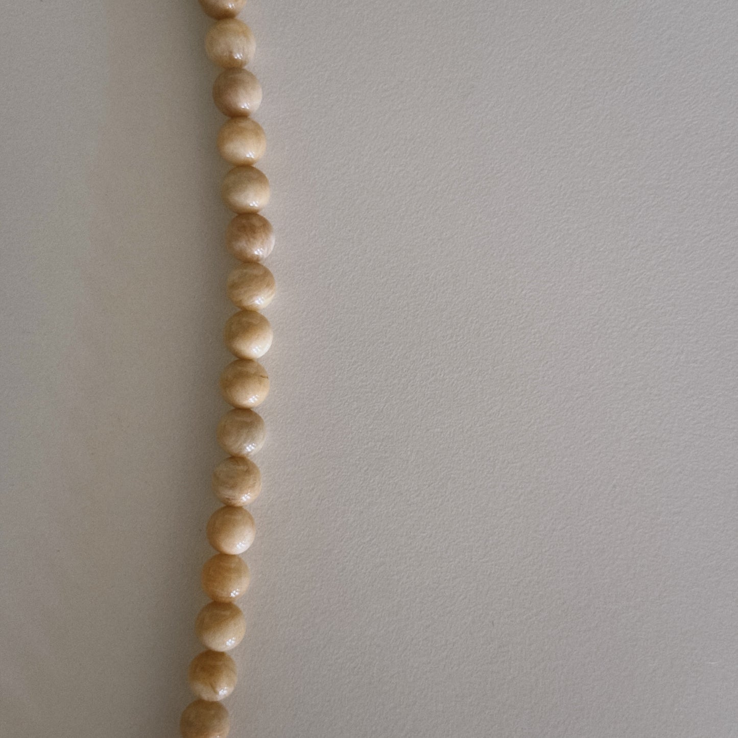 yellow beaded necklace with shell pendant